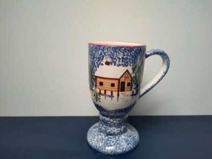 Kubek Cook's Bazaar Gourment Collection ze świątecznym domkiem na tle białej ściany